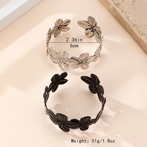 Elegant floral open cuff bracelet in silver and black metal with hollow petal design