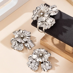 Detailed view of silver flower jewelry set with layered petals and pearl center inlays