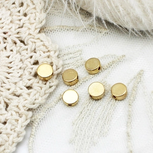 Close-up of 18K gold plated matte round spacer beads with side holes for DIY jewelry