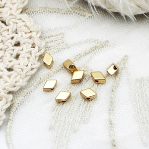 Macro shot of gold plated rhombus spacer beads for DIY jewelry making and necklaces