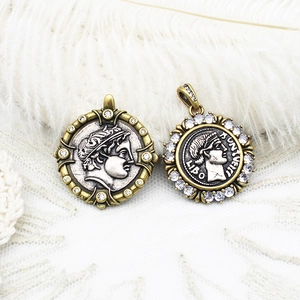 Vintage Greek coin pendants with portrait embossments and zircon detailing on white feathers