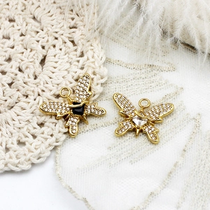 Detailed view of 18K gold plated butterfly pendants with micro-pave zircons and heart stones