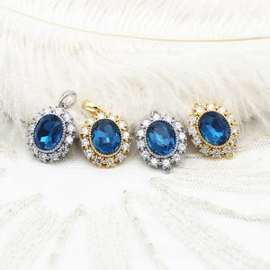 Macro detail of oval blue sapphire pendants with sparkling micro-pave zircon crystals