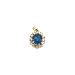 Vintage gold pendant featuring an oval blue sapphire center and micro-paved zircon stones