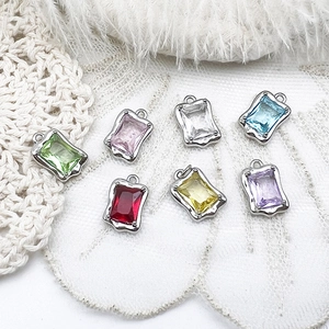 Detailed macro shot of seven colorful rectangular crystal pendants for DIY jewelry design