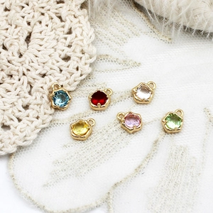 Macro shot of colorful micro-inset teardrop charms for DIY jewelry making sets