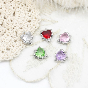 Macro detail of five colorful heart-shaped crystal pendants with silver metal settings