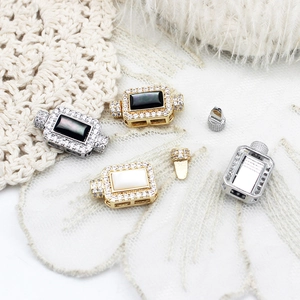 Detailed close-up of shell and onyx rectangular jewelry clasps with micro-pave zircons