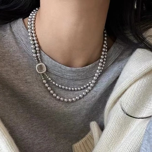 Double-layered silver-grey pearl necklace with a square micro-pave shell clasp accessory