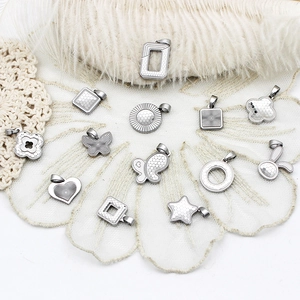 Detailed macro view of CNC cut stainless steel charms with unique laser honeycomb patterns