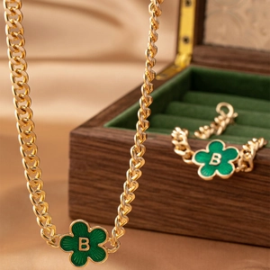 Golden chain jewelry set with green enamel flower pendant and initial B detail
