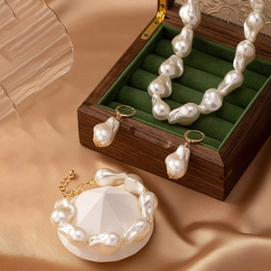 Baroque irregular pearl jewelry set featuring necklace bracelet and earrings on silk