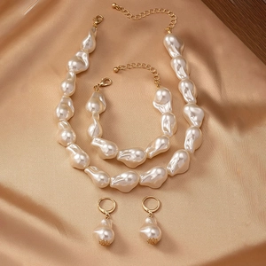Baroque irregular pearl jewelry set with necklace bracelet earrings on champagne satin