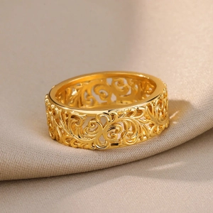 Macro shot of vintage gold-plated ring featuring intricate hollow vine scroll carvings