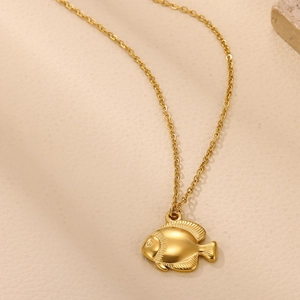 Detailed close-up of 18K gold plated tropical fish pendant with textured scales and fins