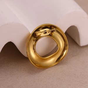 Detailed back view of gold-plated sun brooch featuring secure pin closure and polished finish