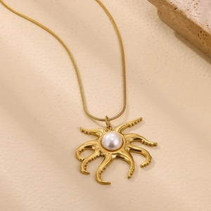 Detailed shot of golden octopus pendant with a large white pearl on a snake chain