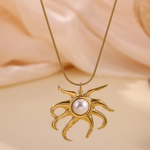 Elegant 18k gold octopus pendant necklace with white pearl on pink silk background