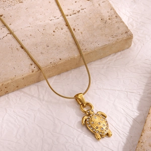 Golden stainless steel turtle pendant necklace with sparkling crystals on a snake chain
