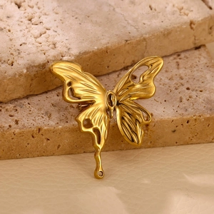 Elegant gold-plated butterfly sun brooch with cutout wings and molten drip design