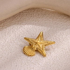 Golden sun and starfish brooch with shell design on an elegant textured base