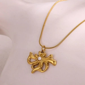 Detail of 18k gold plated stainless steel necklace featuring a pearl butterfly pendant