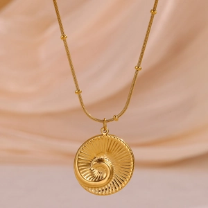 Close-up of 18k gold plated stainless steel spiral seashell pendant on beaded snake chain
