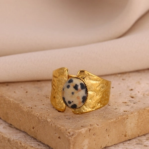 Minimalist golden stainless steel wing ring with oval dalmatian stone and hammered finish