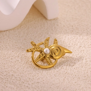 Detailed close-up of a gold-plated sun-shaped brooch with a central white pearl inlay