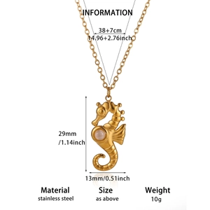 Detail of seahorse pendant necklace in gold stainless steel with a central white pearl bead