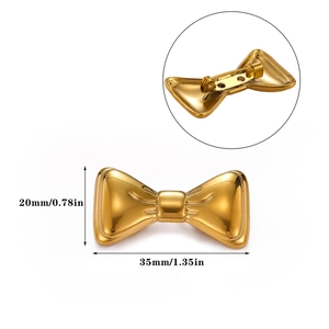 Detailed view of a gold bow brooch showing 35mm width and the back safety pin