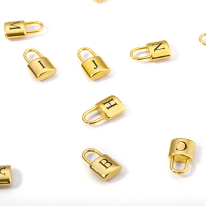 Golden stainless steel lock necklaces with engraved black letters on a white background