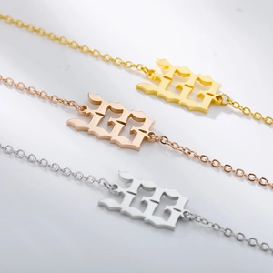 Detailed view of angel number 133 pendants in gold, rose gold, and silver stainless steel