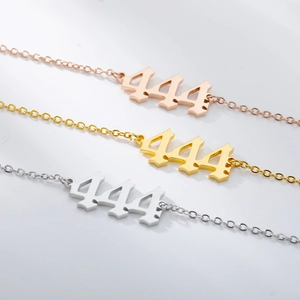Macro detail of three-color 444 angel number anklets in gothic polished steel finish