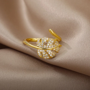 Macro shot of 18k gold monstera leaf ring with pavé sparkling zircon stones
