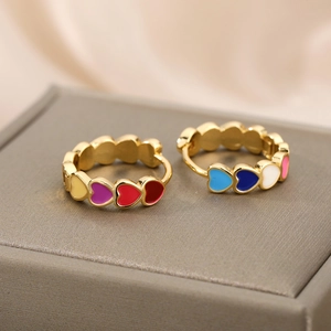 Close-up of colorful heart-shaped hoop earrings with vibrant enamel inlay on display