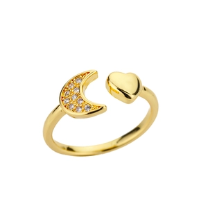 Detail of golden crescent moon ring with sparkling zircon stones and heart shape