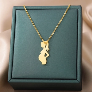 Close-up of golden stainless steel necklace with pregnant woman silhouette pendant