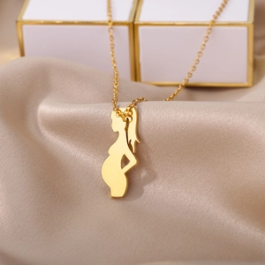 Detail of gold pregnant woman silhouette pendant on champagne satin for Mother's Day gift