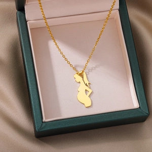 Detailed view of a golden mother and child pendant necklace in a luxury gift box