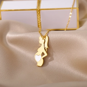 Detailed view of gold-plated mother and child pendant on elegant silk satin background
