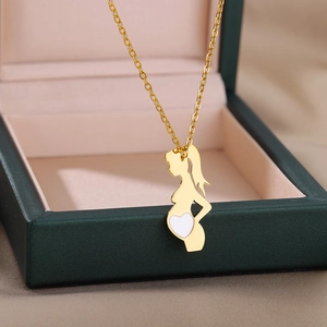 Golden necklace with mother and baby silhouette pendant displayed on a green jewelry box