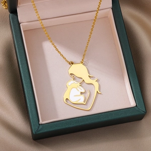 Detail of a golden mother and child pendant necklace in a premium gift box packaging