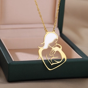 Golden stainless steel necklace featuring a mother holding child pendant on jewelry box