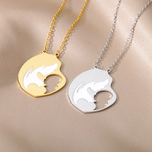 Detail of stainless steel mother and baby silhouette pendants on champagne velvet