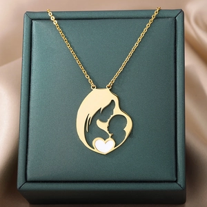 Detail of a golden mother and child silhouette pendant necklace with a white heart accent
