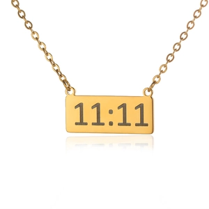 Detailed close-up of rectangular gold pendant with 11:11 angel number engraving