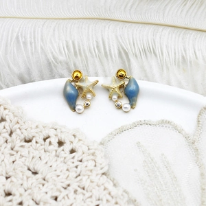 Close-up of S925 silver ocean stud earrings with blue shell, starfish and pearls