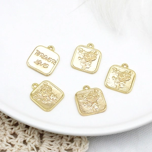Detail of 18K gold-plated square charms with rose relief and Forever Love engraving