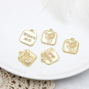 Detail of 18K gold plated square pendants with Forever Love and rose engraving